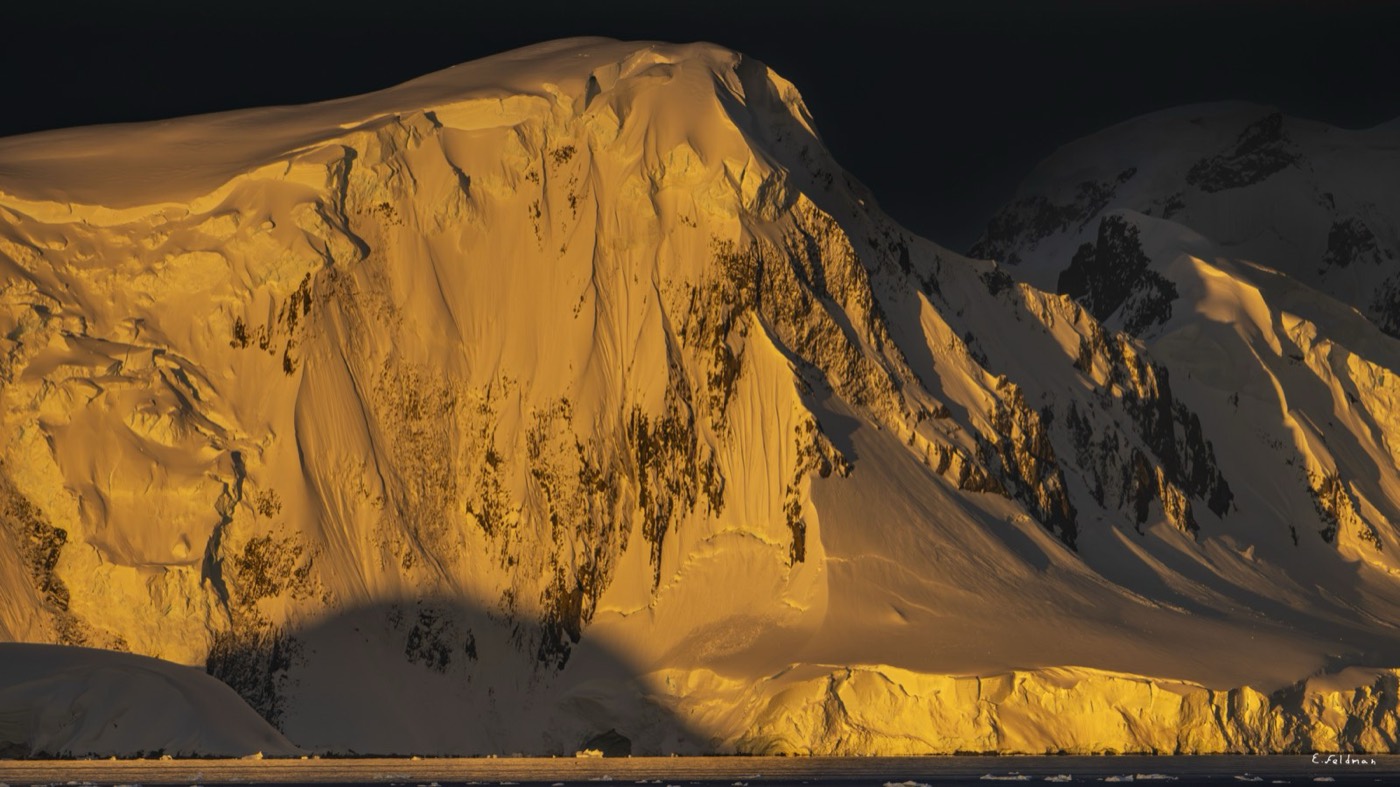Montaña antártica iluminada por el sol del atardecer